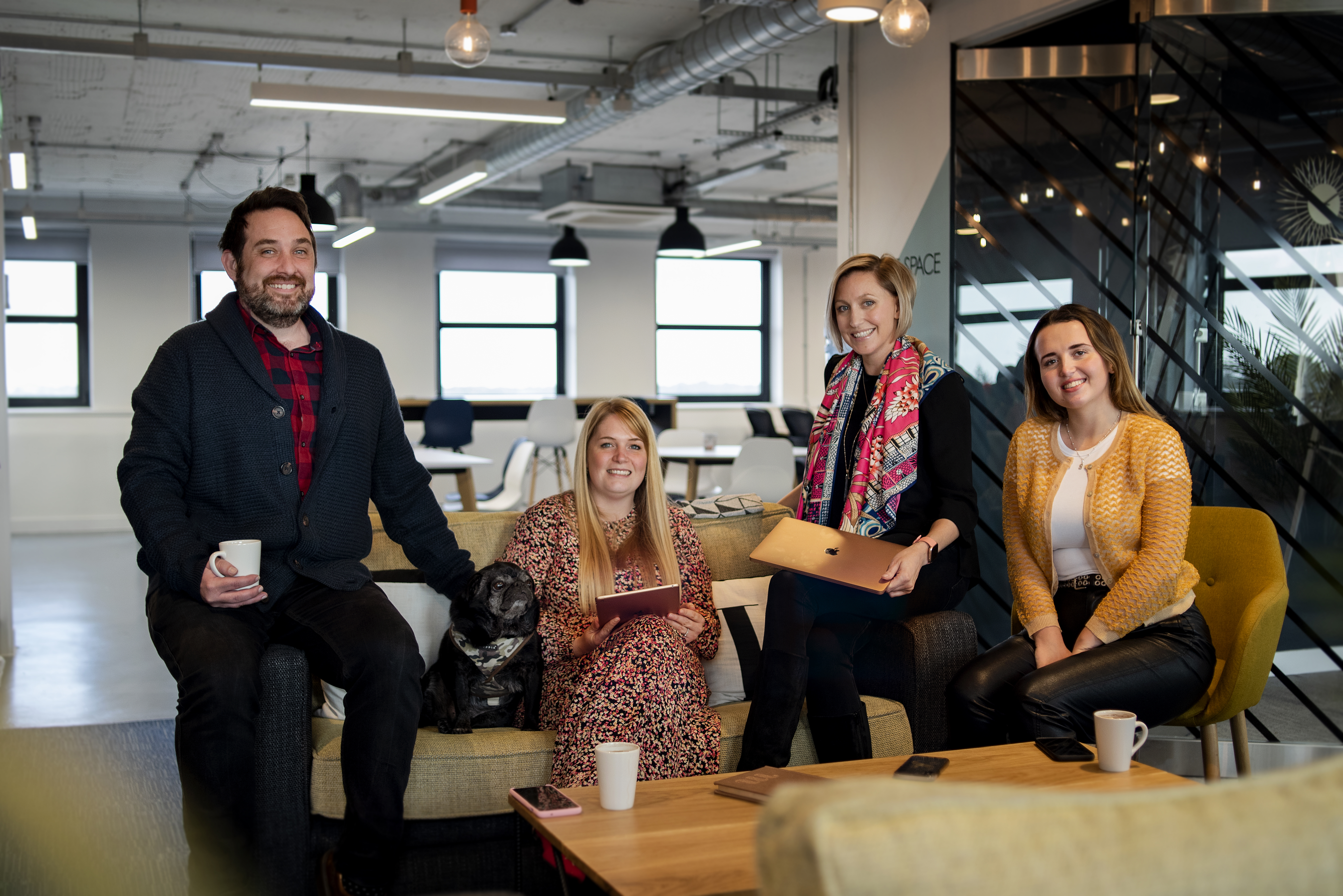 Members of Street Agency sitting at a sofa